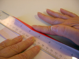 Using a ruler to help with a fold